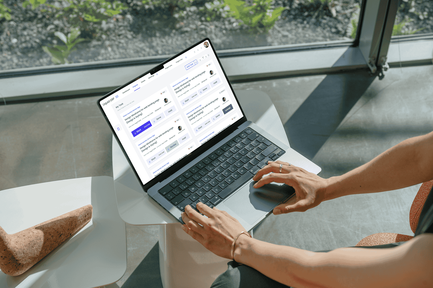 Liquid ERP dashboard on a laptop used near a window