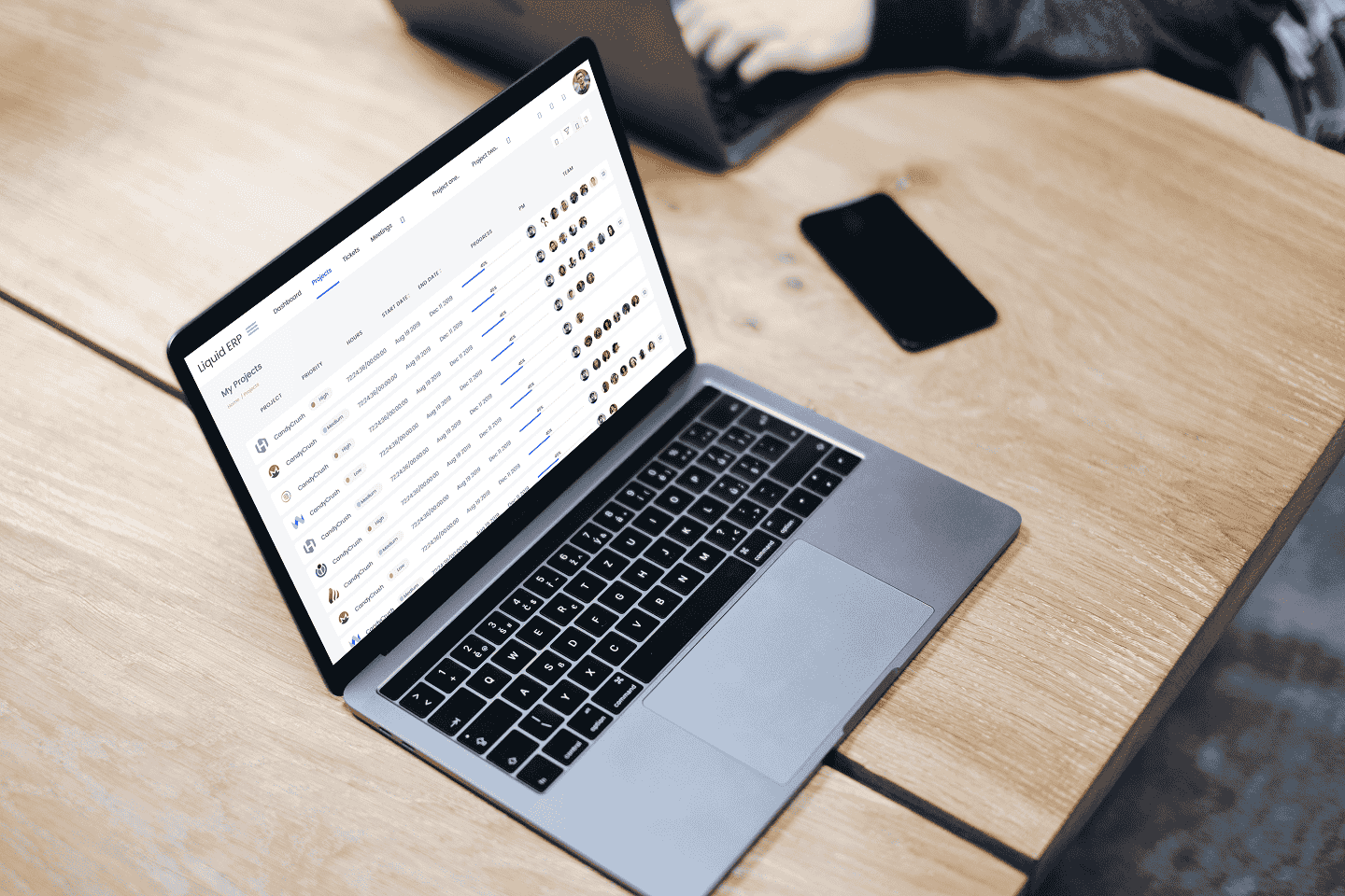 Liquid ERP dashboard on a laptop placed on a wooden desk